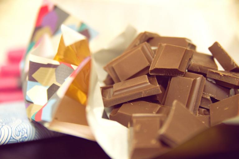 A delicious bar of dairy-free milk chocolate, broken into pieces